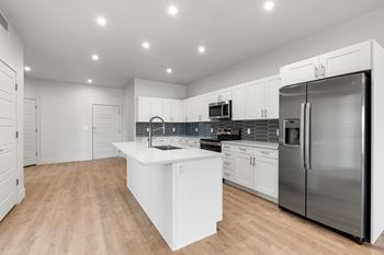 Kitchen with sink, cabinetry and refrigerator